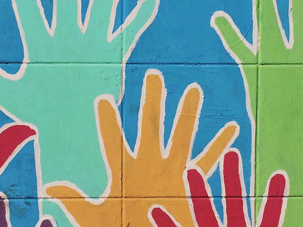 Mural of multi-colored hands raised