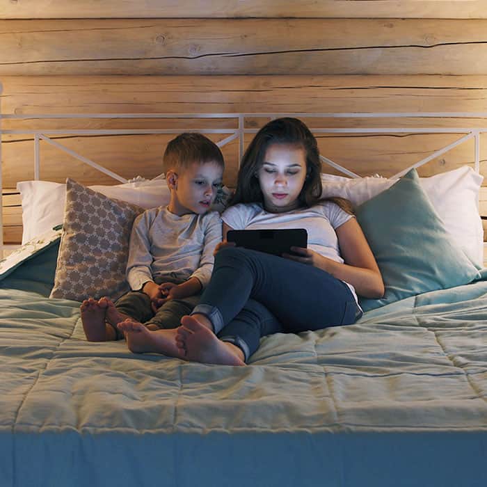 Mother taking online course with child next to her